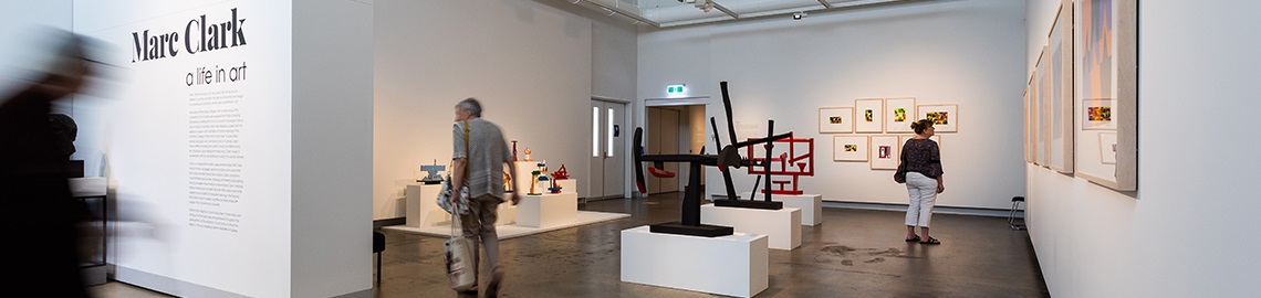 People inside Redcliffe Art Gallery, looking at different exhibits