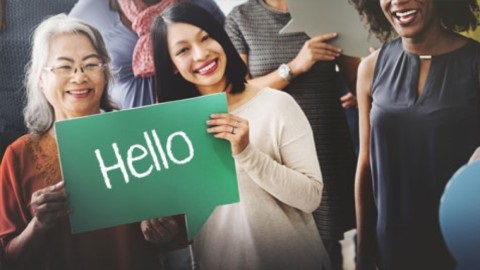 Women holding hello sign
