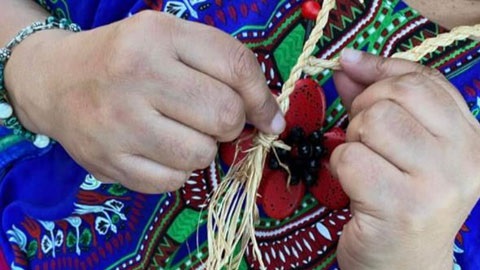 Woman weaving raffia