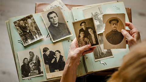 Person holding old photos