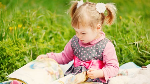 Girl reading a book outdoors