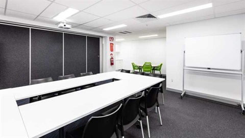Meeting room 1 - Boardroom set up with smaller meeting area