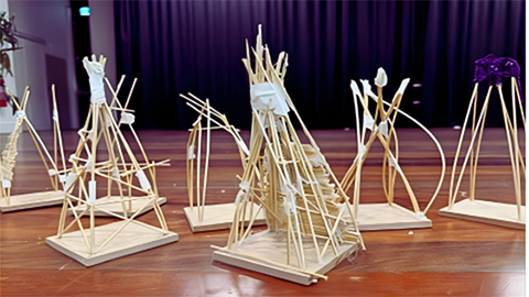 A group of Pacific huts made of bits of match sticks.