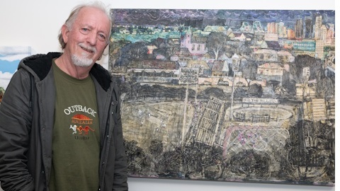 Artist with a painting as part of an exhibition