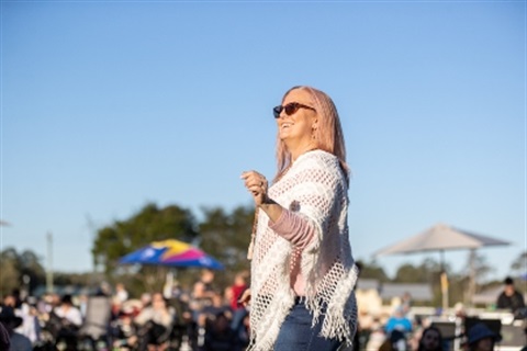 Lady dancing with blue sky in the background