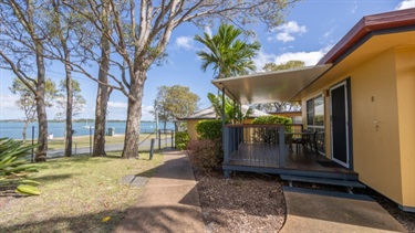 Bongaree Caravan Park cabins with foreshore in background