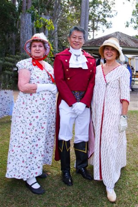 Three people dressed in historical outfits