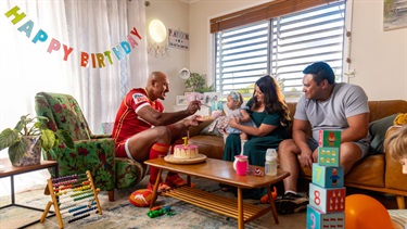 A mum and dad celebrating their daughter's first birthday at home with Felise Kaufasi.