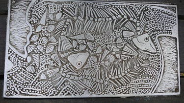 Silver rubbing plaque with fish and shells