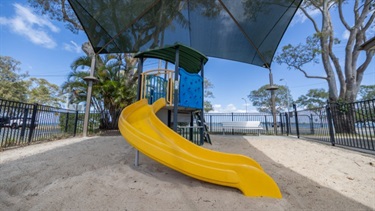 Covered playground with a slide at the Bongaree Caravan Park