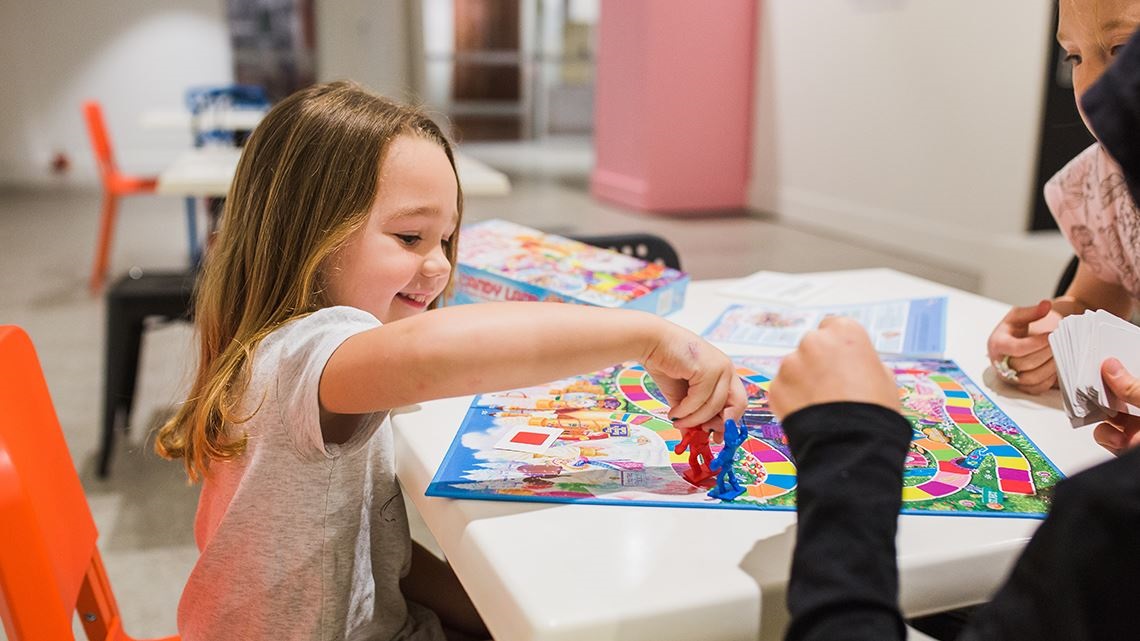 Young girl playing board game