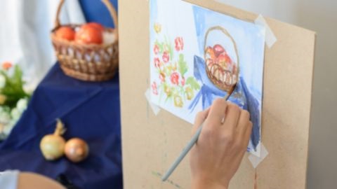 Person painting a bowl of fruit