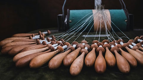 Lacemaking wooden bobbins in a row