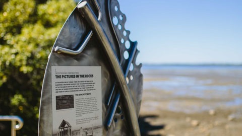 Sign showing historic landmark near beach