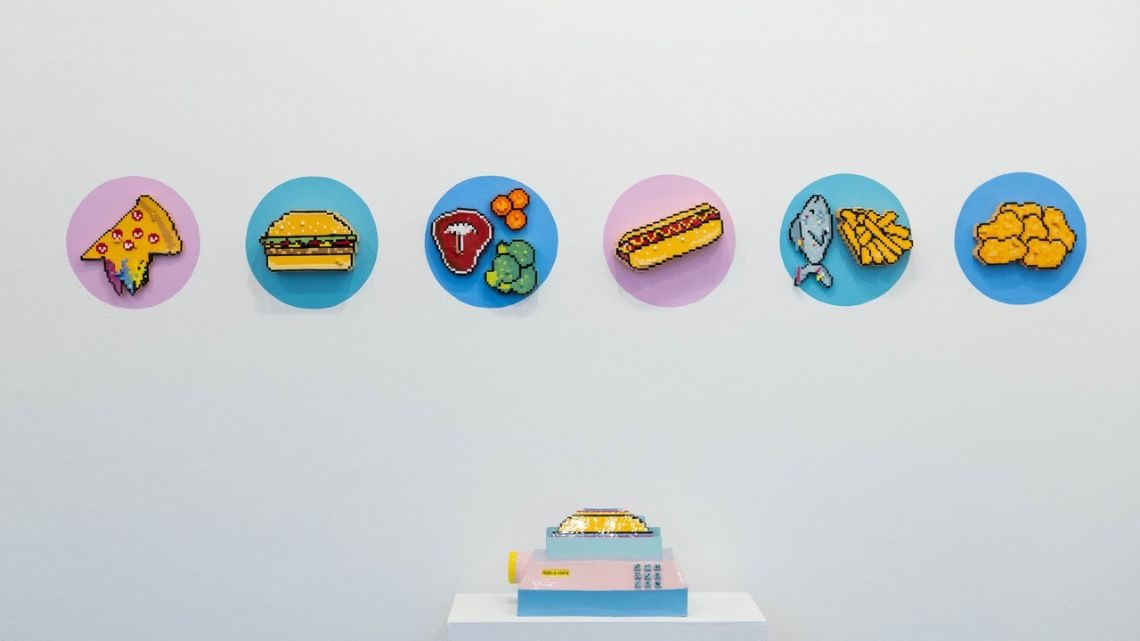 Printed pictures of different foods on a gallery wall