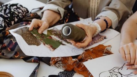 Person comparing fabric samples