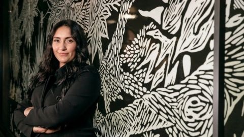 Woman in front of black and white artwork- Tamika Grant-Iramu