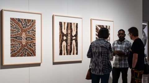 People looking at indigenous art