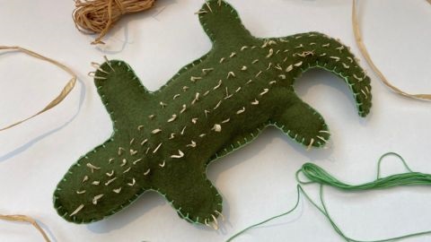 Green crocodile shaped stuffed toy