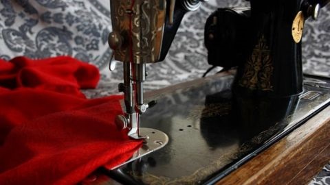 Vintage sewing machine with red material