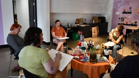 Women sitting in a circle at art class