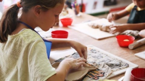 Kids moulding clay shapes