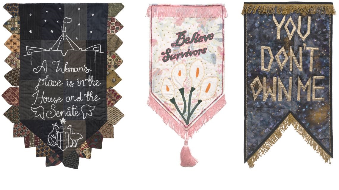 Three handmade banners with political slogans