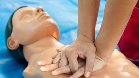 Person performing CPR on dummy