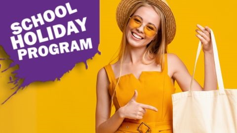 Teen girl pointing to tote bag with yellow background