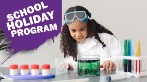 Girl with black hair performing science experiments