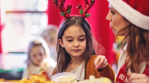 Girl wearing Christmas reindeer headpiece