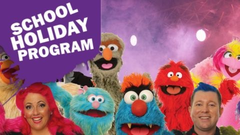 Group of furry puppets with puppeteers