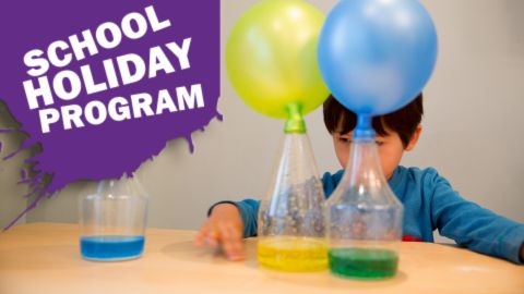 Child experimenting with balloons in bottles