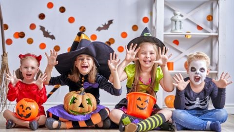 Kids sitting on floor in Halloween costumes