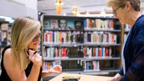 Two women at library desk