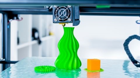 3D printer producing a lime green object