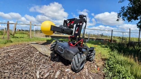 Robot vehicle holding yellow ball