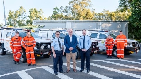 A photo of City of Moreton Bay Mayor Peter Flannery with members of the SES and their new vehicles.