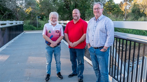 Councillor Mick Gillam, Kurwongbah MP Shane King and Mayor Peter Flannery stand on the new Ron Thomason Park walkway pedestrian bridge