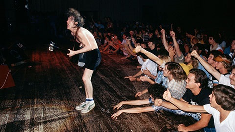 ACDC okay on a wooden stage while crowd cheers