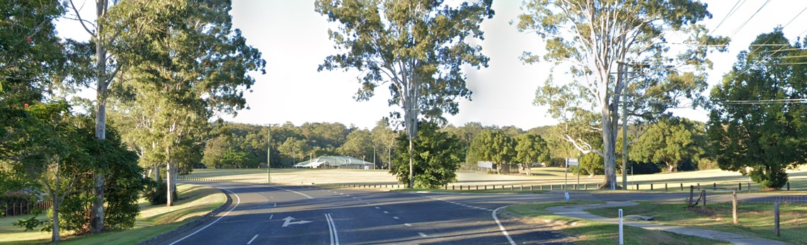 An intersection with trees and open space