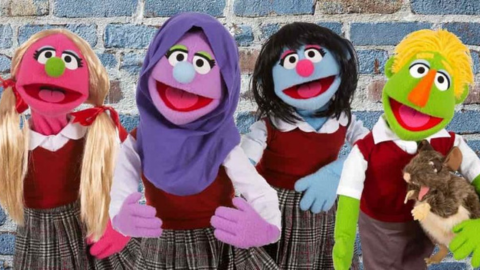 four puppets all dressed in school uniforms and smiling at the camera