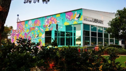 Photograph of the exterior of Bribie Island Library, featuring a colourful mural covering one side of the building.