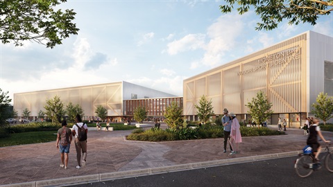 Big building reading Moreton Bay Indoor Sports Centre in between lush green gardens and footpaths.