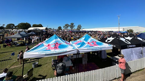 A crowd of people and market stalls