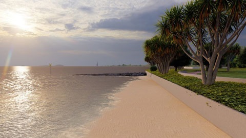 Sandy foreshore with calm water at sunset, bordered by a walkway lined with trees and low greenery.
