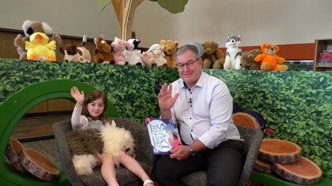 Mayor Peter Flannery with daughter sitting with book for National Simultaneous Storytime.jpg