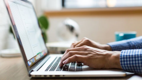Person typing on laptop