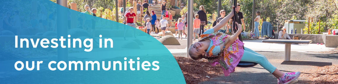 Banner 'Investing in our communities' with a young girl on a rope swing at local park