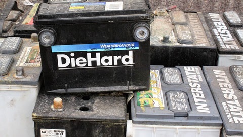 Pile of vehicle batteries of various makes and models